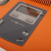 A close-up of the LCD screen on a bright orange defibrillator