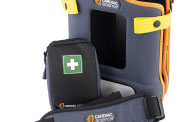 A close-up of a grey and orange defibrillator case