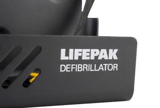 A close-up of a dark grey defibrillator wall bracket