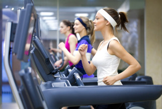 3 people running on treadmills in a gym