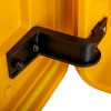 close up shot of a black hinge attached to a yellow plastic door and frame