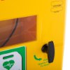 Black handle on a yellow polycarbonate outdoor defibrillator cabinet heating light showing part of the front panel and warning labels