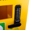 Close-up of polycarbonate outdoor defibrillator cabinet showing yellow surface with black lock, keypad, handle and heating light indicator