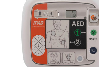 A white fully automatic defibrillator with an orange strip