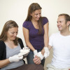 a group of adults practicing putting bandages on arms