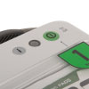 A close-up of the green power button on a white defibrillator
