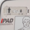 A close-up of the adult / child mode button