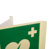 A close up image of a panoramic aed wall sign with a green background a first aid cross in the top right corner
