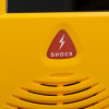 A close-up of the shock LED on a yellow defibrillator