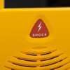Closeup of the shock button on the defibtech lifeline view semi automatic defibillator in yellow casing