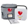 physio control lifepak cr2 trainer unit showing the main device, a grey carry case with heart logo, and an instruction manual