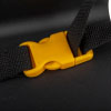 a close up of a yellow plastic buckle with black webbing straps connecting to it