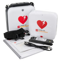 A white defibrillator with a red logo and all of its contents