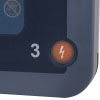 A close-up of the orange shock button on a blue defibrillator