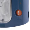 A close-up of an orange shock button on the front of a blue defibrillator