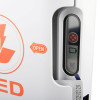Close‑up of AED indicator window showing fault, battery, and pad icons next to an orange “OPEN” arrow.