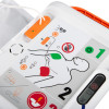  Instruction panel showing adult pad placement diagrams, numbered steps, and icons for shock and safety warnings.
