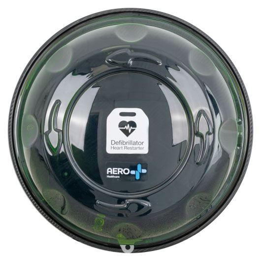 looking directly at a circular clear green plastic defibrillator cabinet, there are 2 stickers visible one is in white and says defibrillator heart restarter and the other in the earo healthcare logo in white and blue