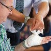 a man showing how to put a bandage on his hand