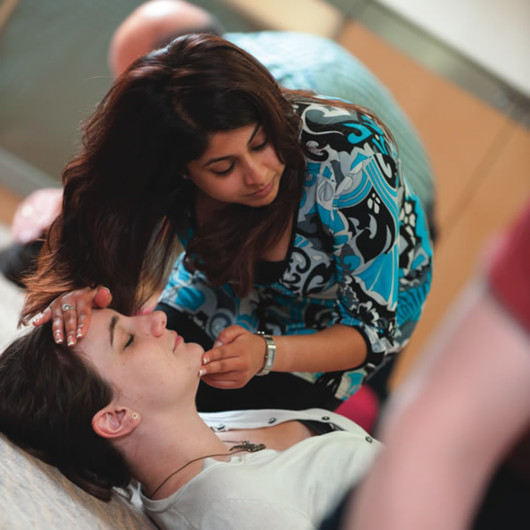 a woman checking for breathing for the cpr process