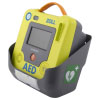 grey plastic wall bracket with the Zoll aed 3 defibrillator shown inside, on the side is a defib logo a white heart and cross on a green background to denote a piece of first aid equipment