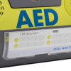 a close up of the zoll aed 3 defib wall bracket, on the front is a label where you can hand write on the expiry dates of the pads and batteries