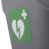 a close up side view of a  grey plastic wall bracket with a green label with a white heart and white cross denoting first aid equipment 