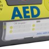 Closeup of the zoll aed 3 defibrillator wall mounted bracket showing part of the device and label