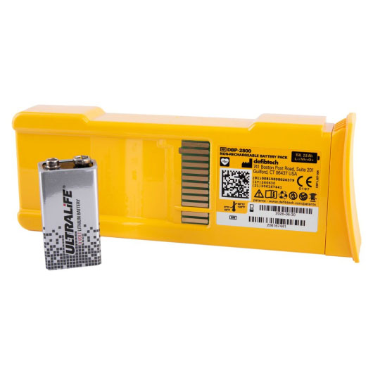 a yellow rectangular battery with black writing showing the manufacturer and ce mark, in front is a grey 9v battery with the word ultralife written on it