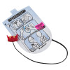 a pale blue and black foil pouch with a drawing of a boys torso showing where the training defibrillator pads should be placed. There is a bright pink label with black writing stating training pads 