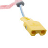 a close up of the pale yellow connector with two round holes to connect to the trainer defib with a blue and white lead 