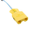 a close up of a pale yellow plastic connector block for attaching to a training defibrillator 