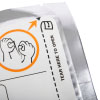 a close up of the corner of the silver foil packet with white label on the front, an orange circle with an infographic showing a pair of hand tearing open the foil packet to gain access to the training pads within 