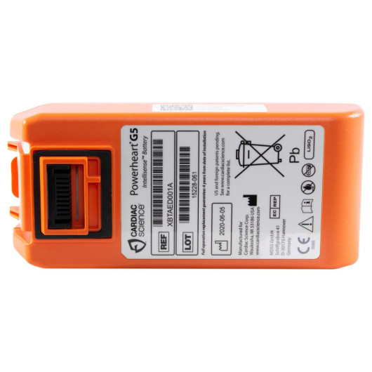 orange cardiac science defibrillator battery with a white label with the manufacture name, address, date of manufacture and safe disposal instructions