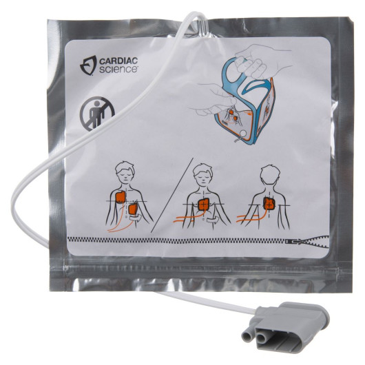 a silber foil packet with a white label with cardiac science in the top left hand corner there is a drawn image of a young male showing the correct pad placement to aid in training
