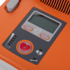 a close up view of the operation panel with the shock button and status leds for battery, pads, and maintenance
