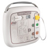 Front view of an AED training device with illustrated pad‑placement diagram, coloured control buttons, and a yellow cable connector attached on the right