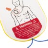 Close up of a training warning label on philips heartstart hs1 adult training pads showing a diagram of pad placement on a torso