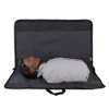 Laerdal Little Anne training manikin with dark skin tone lying inside an open black carry bag