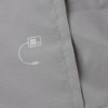 Close up of the jacket on the laerdal little anne training manikin with bag light skin showing fabric texture and a small printed white symbol