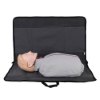 Laerdal Little Anne training manikin with bag in light skin tone lying on a grey mat inside the open bag
