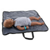a dark skinned training manikin for practicing rescue breaths and CPR laid on a blue mat