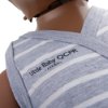 Close-up of the laerdal little baby qcpr training manikin with carry bag dark skin wearing a grey and white striped outfit