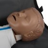 Closeup of laerdal little junior qcpr paediatric training manikin dark skin head resting on a black bag