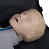 Closeup of laerdal little junior qcpr paediatric training manikin light skin resting on a black bag
