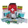 a red plastic carry case with a black handle with a white cross and the words first aid. In front is the contents of the trauma kit including blue gloves, tourni-keys, clothing shears and bandages 