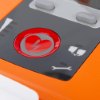 Closeup of red button with heart and lightning symbol on cardiac science powerheart g5 semi automatic defibrillator