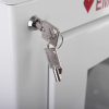 a close up of two silver coloured metal keys in the top left hand corner of a white metal cabinet 