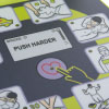 a close up view inside the training defibrillator showing pictorials on how to check a patient and use the AED including the shock button