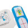 an infographic showing the correct placement where the hands should be placed to perform cpr, there is a smaller infographic showing which way round the pad set should be placed on the torso
